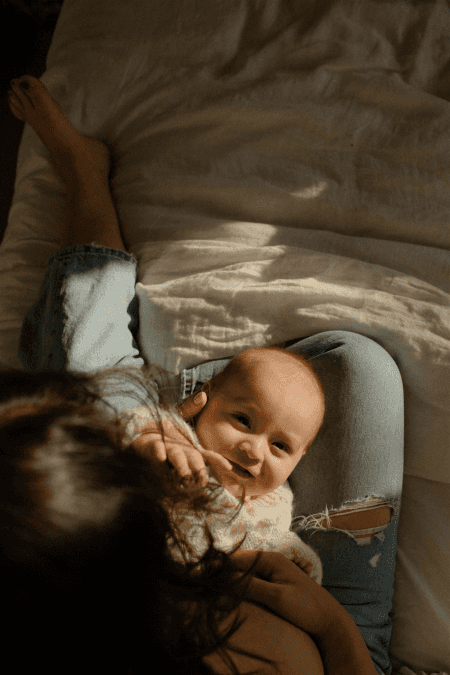 Baby boys head in sunlight reaching to camera